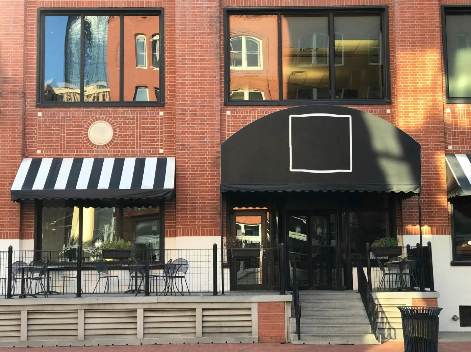 Red-brick commercial premises with awnings over the shopfronts