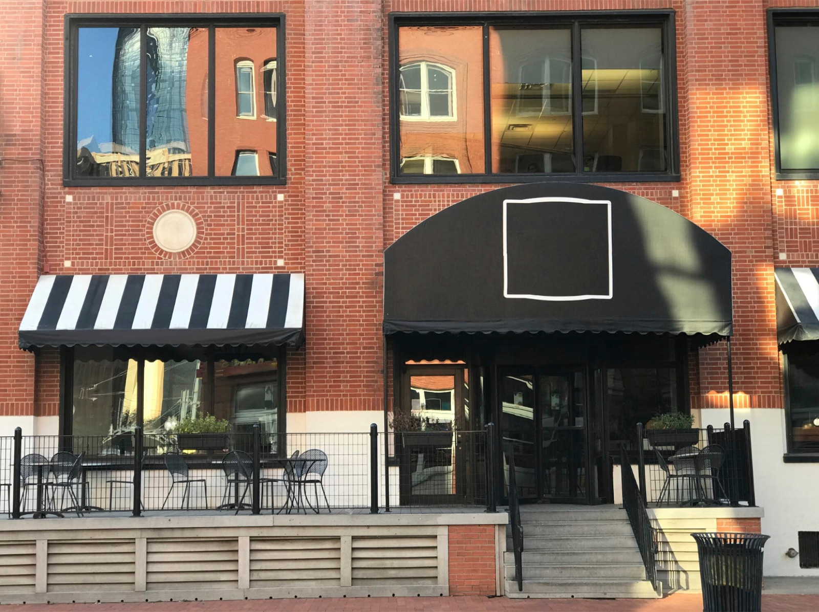 Red-brick commercial premises with awnings over the shopfronts