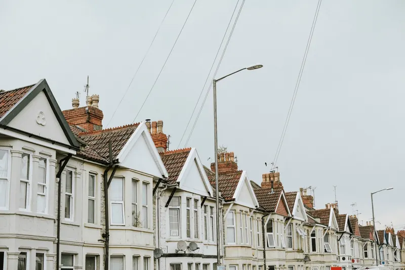 A row of rendered terraced houses seen from the rooftops