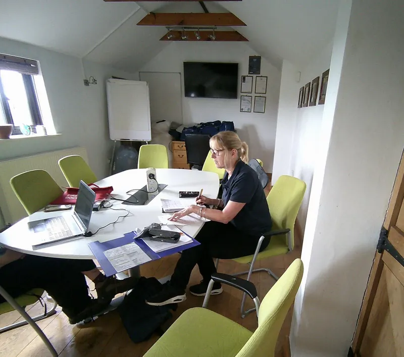 A PALS assessor working through paperwork in the office