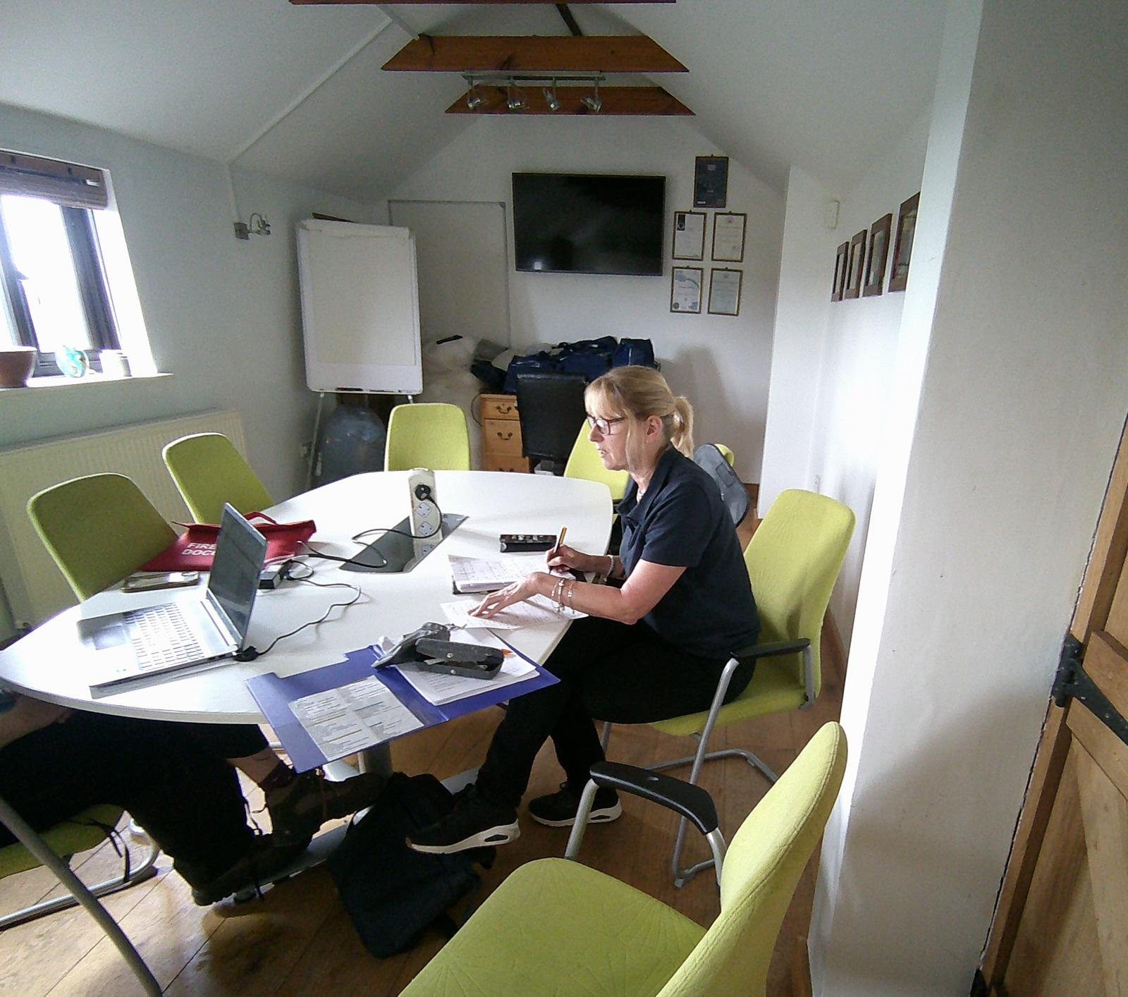 A PALS assessor working through paperwork